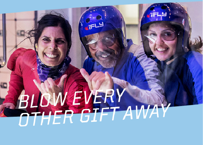 three people smiling and wearing iFly gear