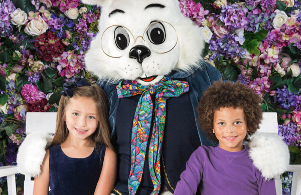 giant bunny with two children standing by their side