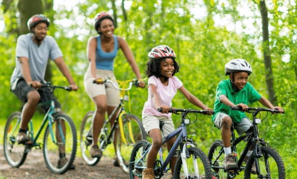 family riding bicycles outdoors
