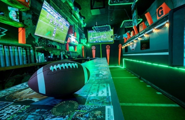 football on a bar table that is lit up green