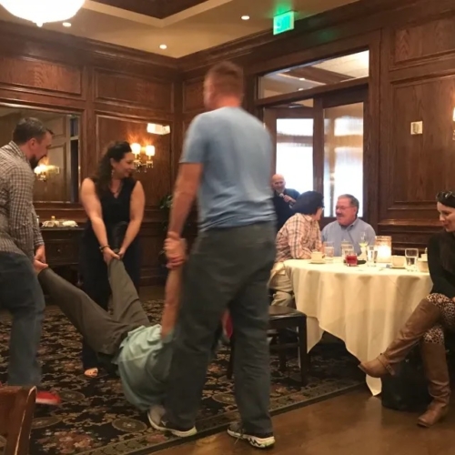 people carrying another person in a restaurant