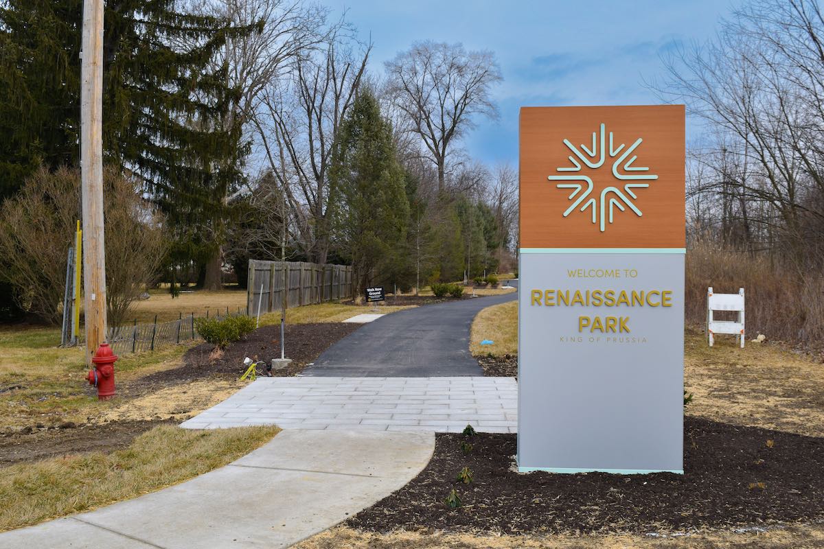 Renaissance Park sign in front of a pathway outdoors